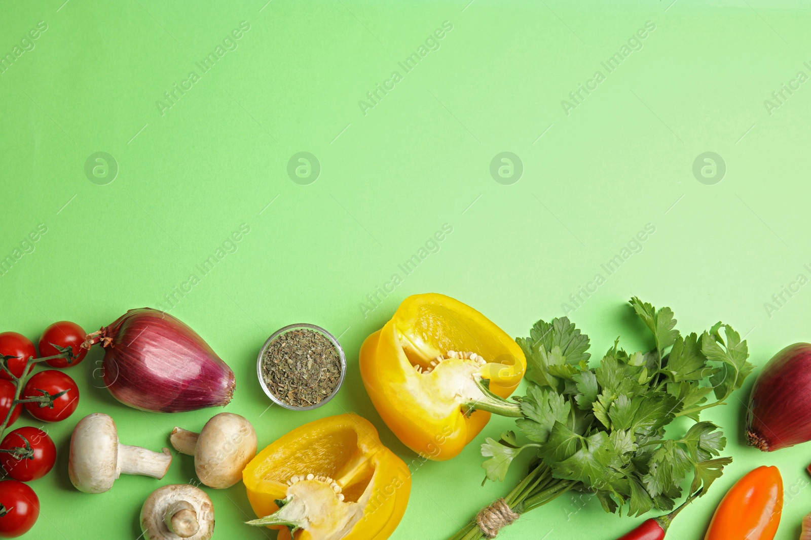 Photo of Flat lay composition with ingredients for cooking on green background. Space for text