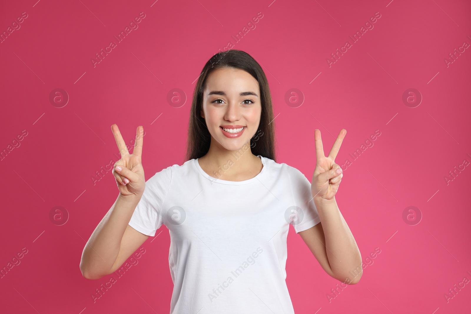 Photo of Woman showing number four with her hands on pink background
