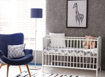 Photo of Cozy baby room interior with comfortable crib
