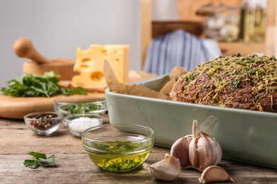 Photo of Tasty homemade garlic bread with cheese and herbs on wooden table