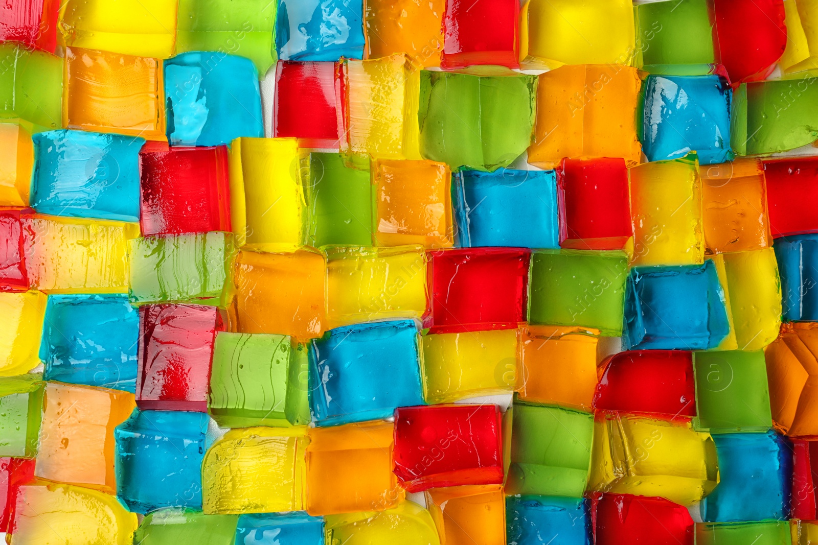 Photo of Tasty colorful jelly cubes as background, top view