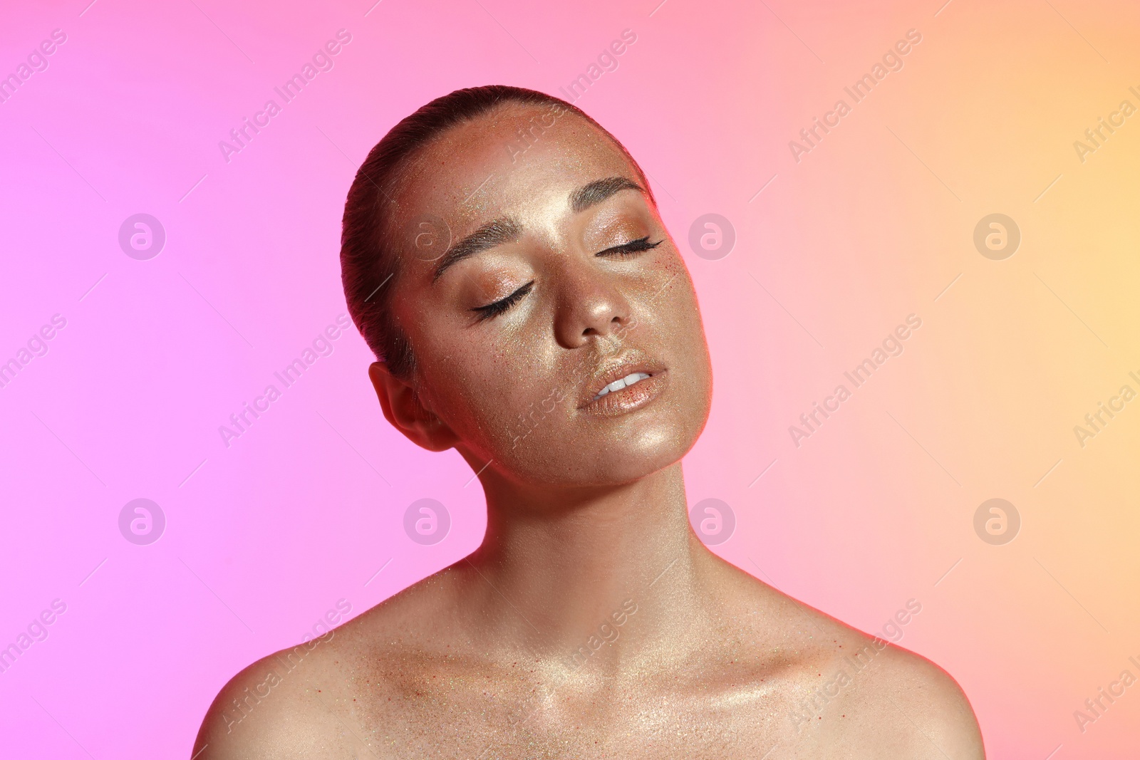 Photo of Beautiful young woman with glitter makeup on colorful background