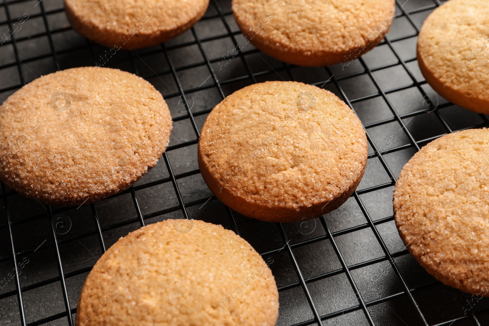 Photo of Baking grid with Danish butter cookies on table, closeup