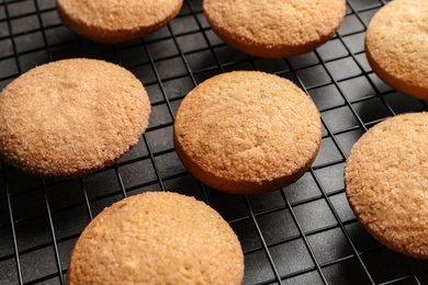 Photo of Baking grid with Danish butter cookies on table, closeup