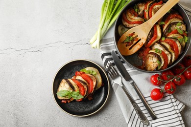 Photo of Delicious ratatouille served with basil on light grey table, flat lay. Space for text