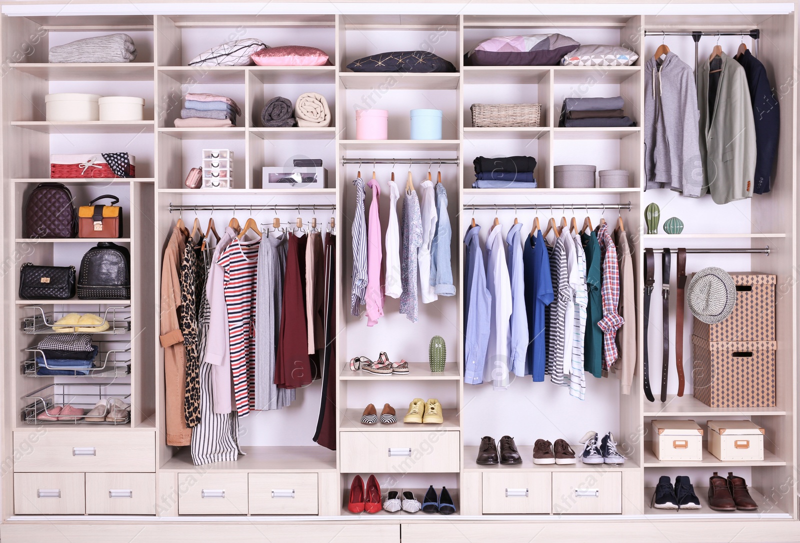 Photo of Large wardrobe with different clothes, home stuff and shoes