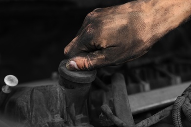 Dirty mechanic fixing car, closeup of hand