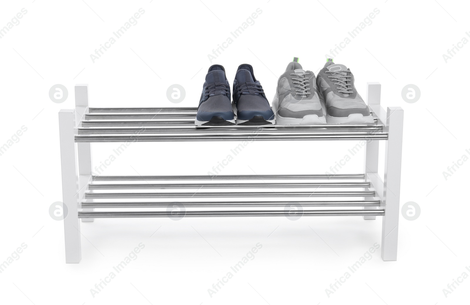 Photo of Wooden shoe shelf with sneakers isolated on white
