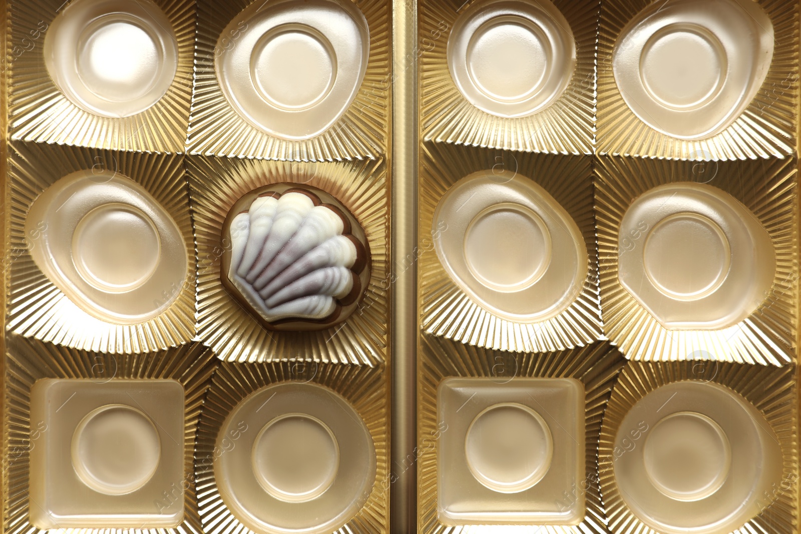 Photo of Partially empty box of chocolate candies as background, top view