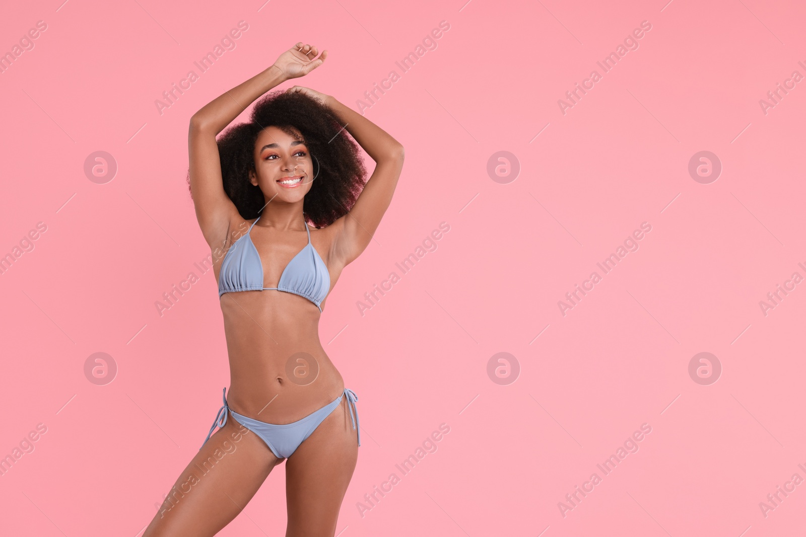 Photo of Beautiful woman in stylish bikini on pink background, space for text