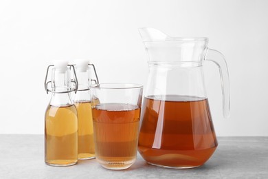 Photo of Homemade fermented kombucha on light grey table