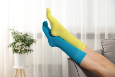 Photo of Woman in different stylish socks indoors, closeup