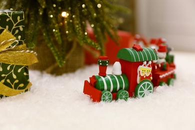 Bright toy train on artificial snow. Christmas atmosphere