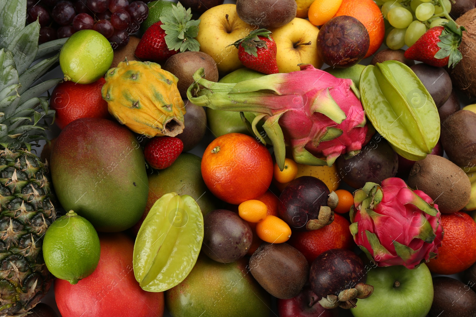 Photo of Assortment of fresh exotic fruits as background, top view