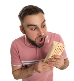 Photo of Emotional young man with delicious shawarma on white background