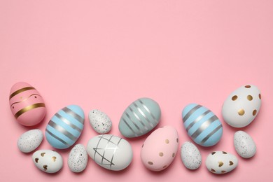 Photo of Many painted eggs on pink background, flat lay. Space for text