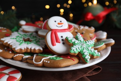 Delicious gingerbread Christmas cookies on wooden table, closeup