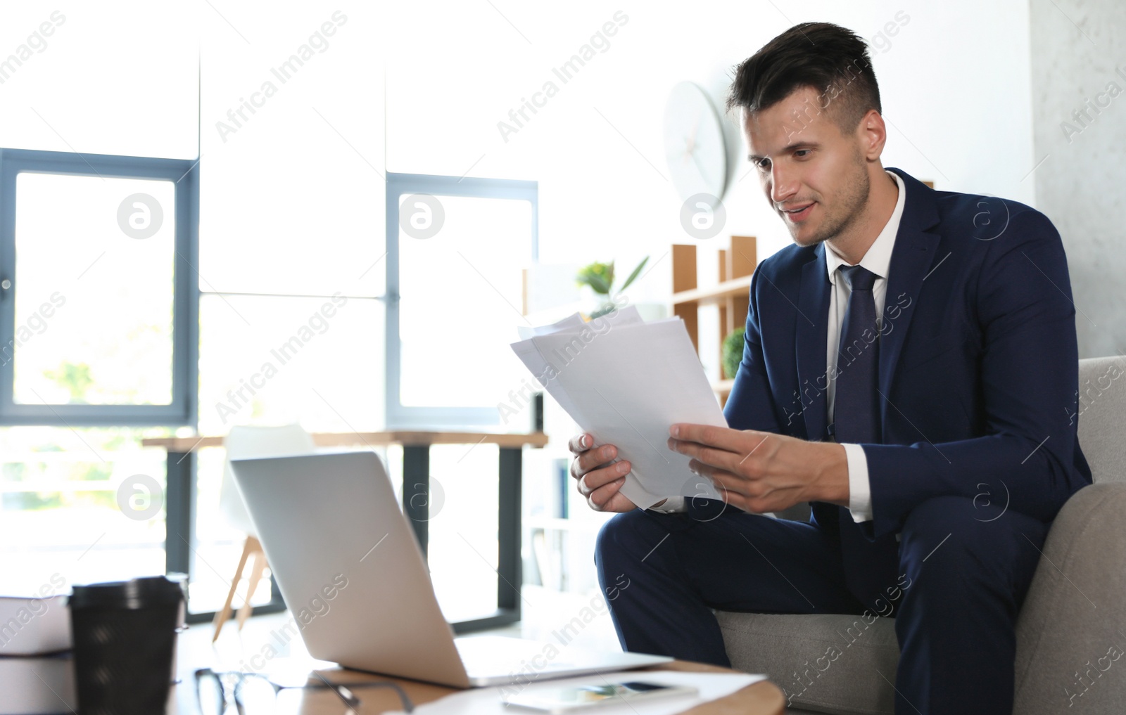 Photo of Male business trainer working with documents in office