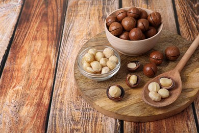 Delicious organic Macadamia nuts on wooden table. Space for text