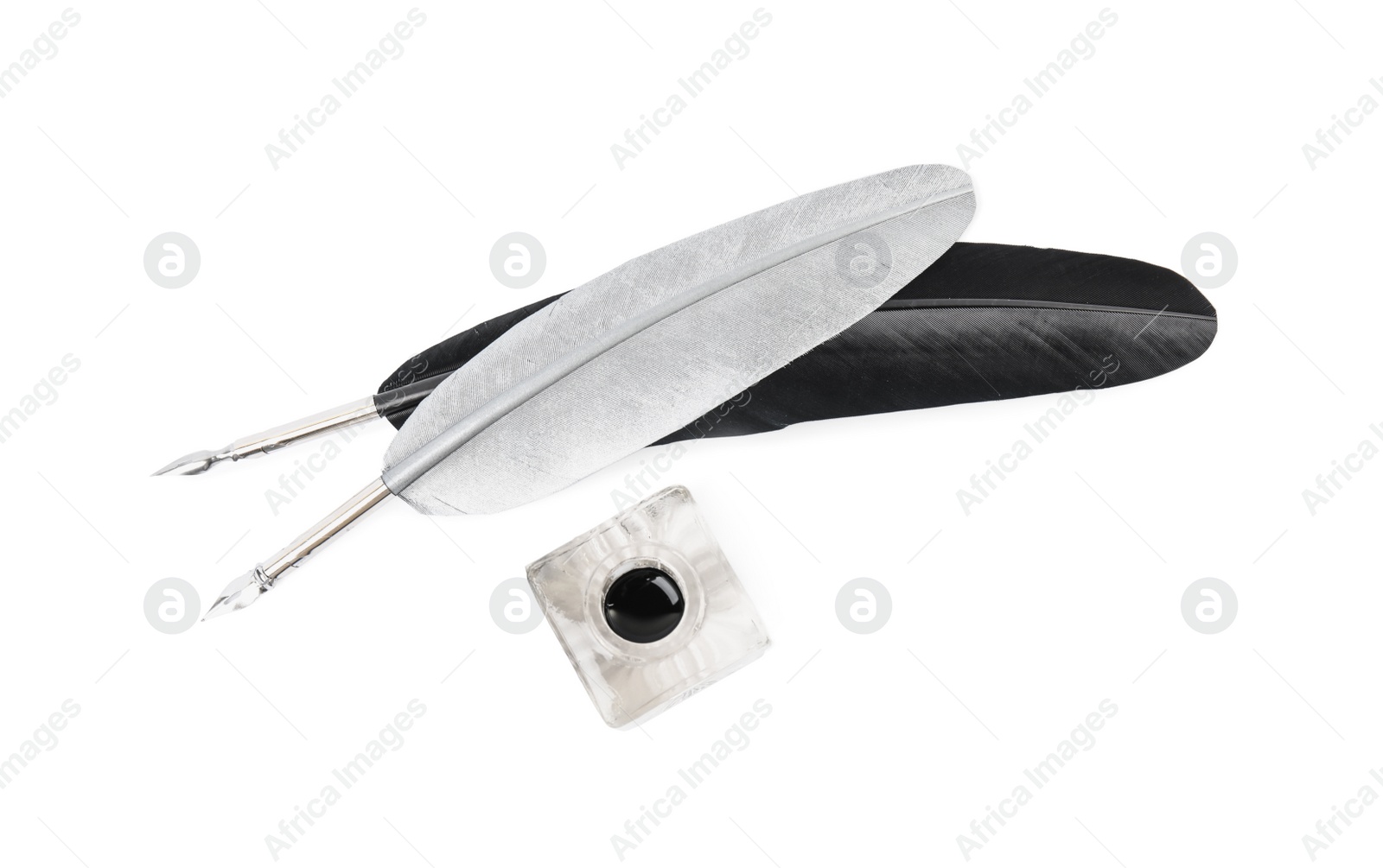 Photo of Feather pens and inkwell on white background, top view