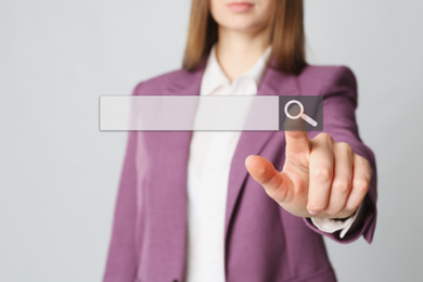 Businesswoman using search bar on virtual screen, closeup