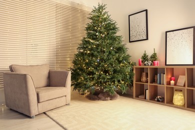 Photo of Beautiful Christmas tree with golden lights in living room