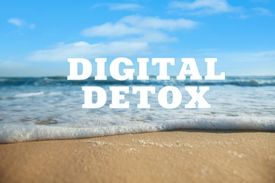Image of Text Digital Detox and beautiful view of sea waves rolling on sandy beach as background