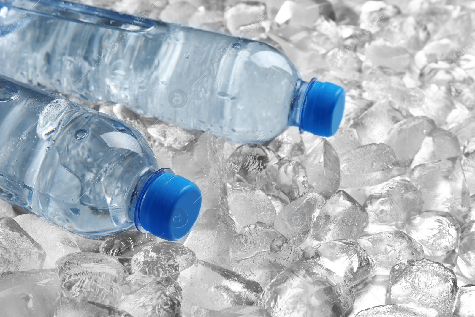 Photo of Bottles of water on pile of ice cubes