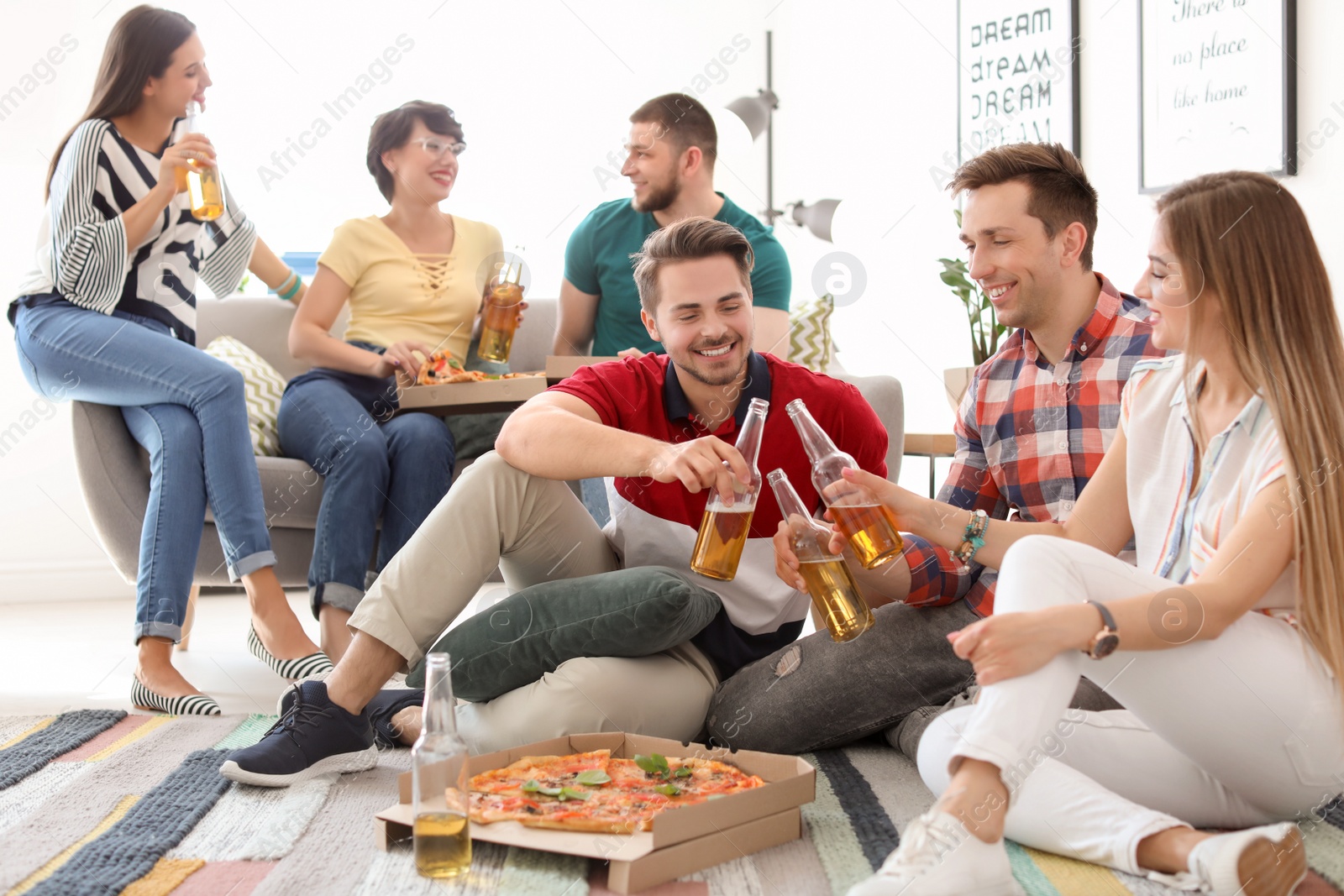 Photo of Young people having fun party with delicious pizza indoors