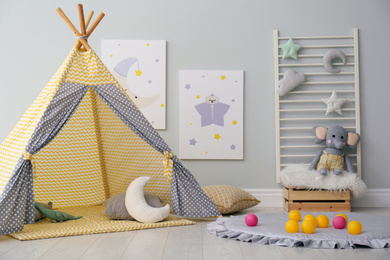 Stylish child's room interior with adorable paintings and play tent