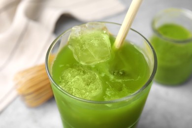 Photo of Glass of delicious iced green matcha tea, closeup