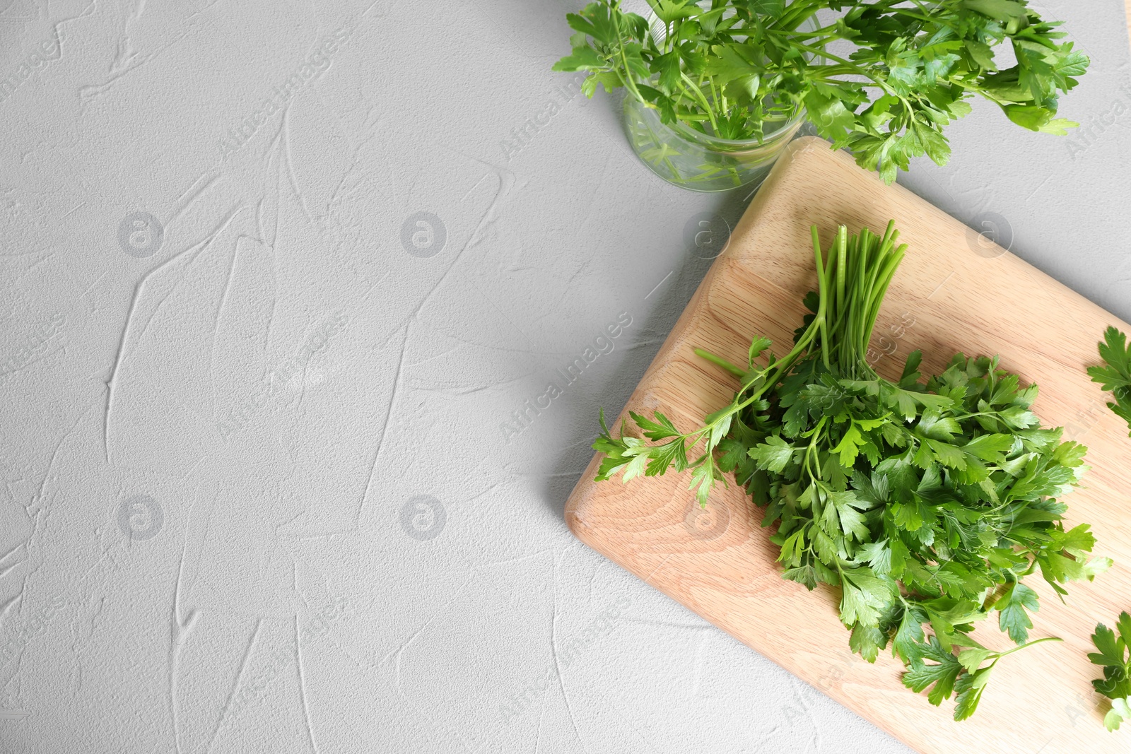 Photo of Flat lay composition with fresh green parsley and space for text on grey background