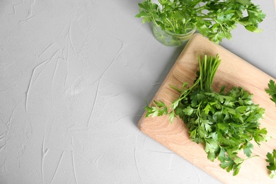 Photo of Flat lay composition with fresh green parsley and space for text on grey background