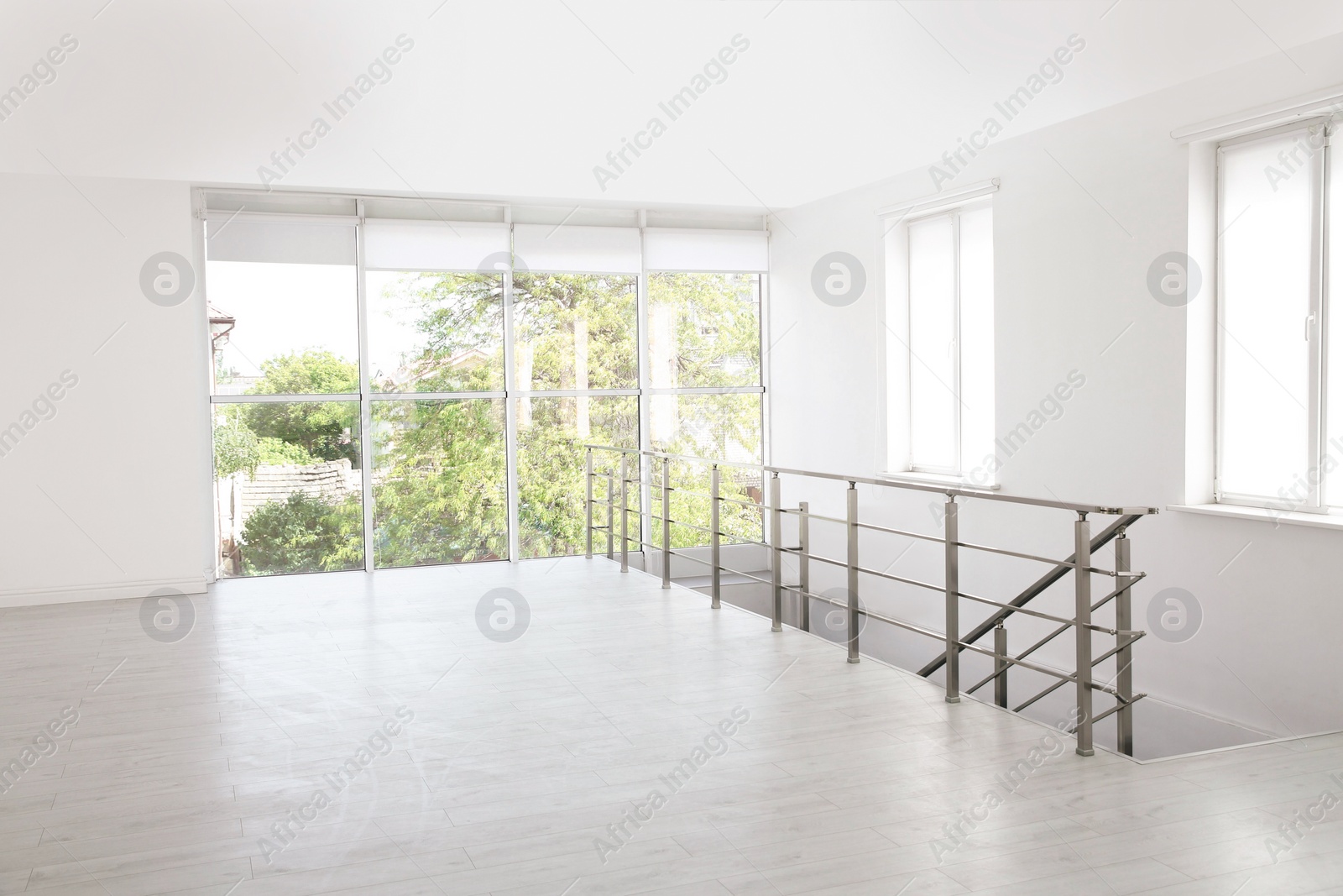 Photo of Empty room with windows and laminated floor