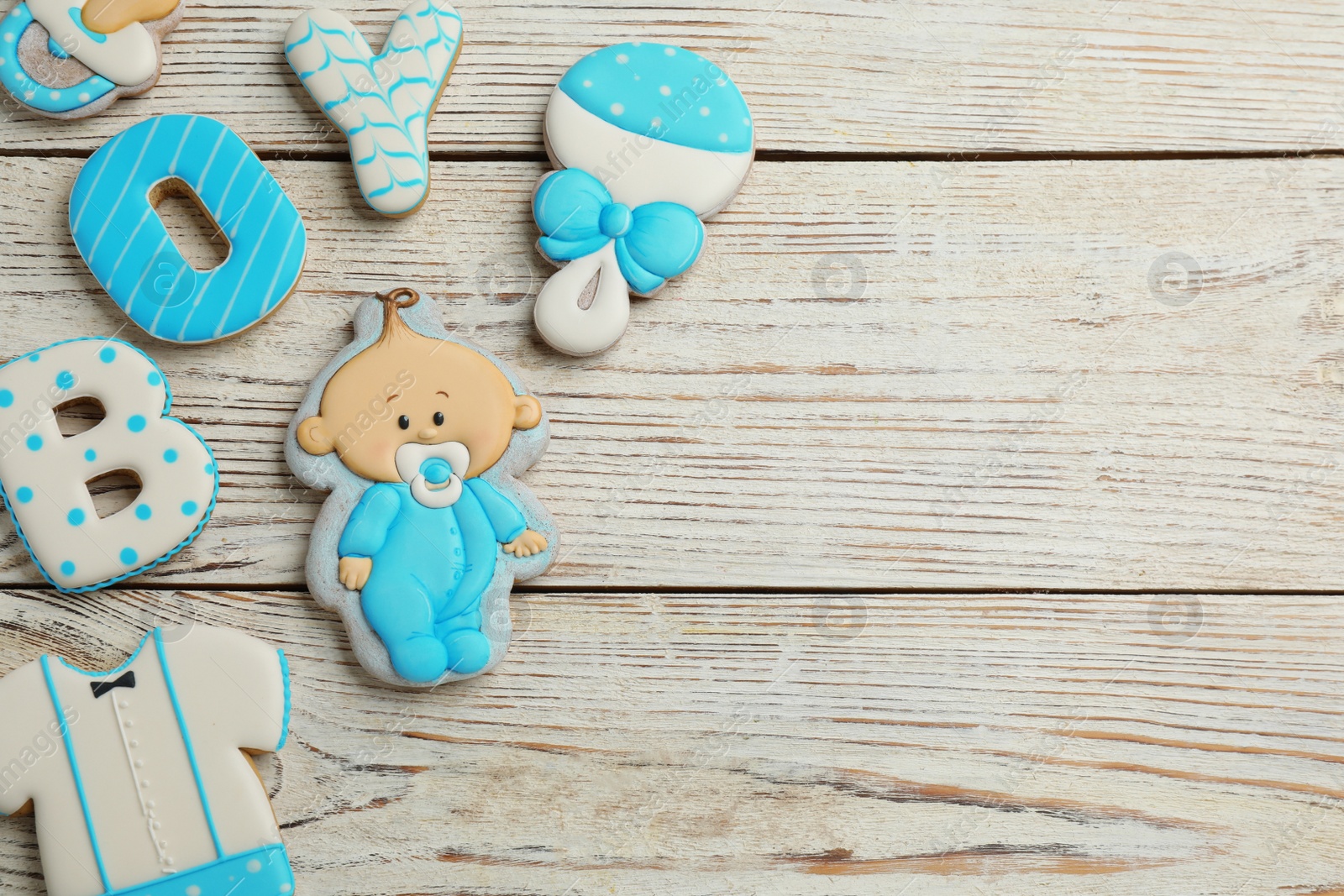 Photo of Word Boy, tasty cookies and space for text on white wooden table, flat lay. Baby shower party