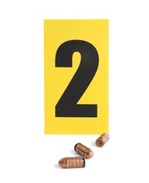 Photo of Bullets and crime scene marker with number two isolated on white