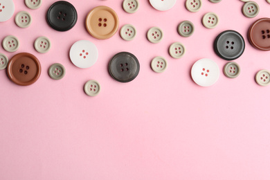 Photo of Many sewing buttons on pink background, flat lay. Space for text