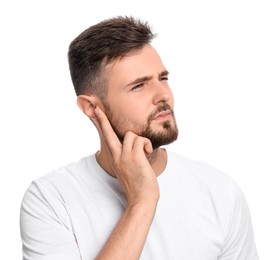 Photo of Young man suffering from ear pain on white background