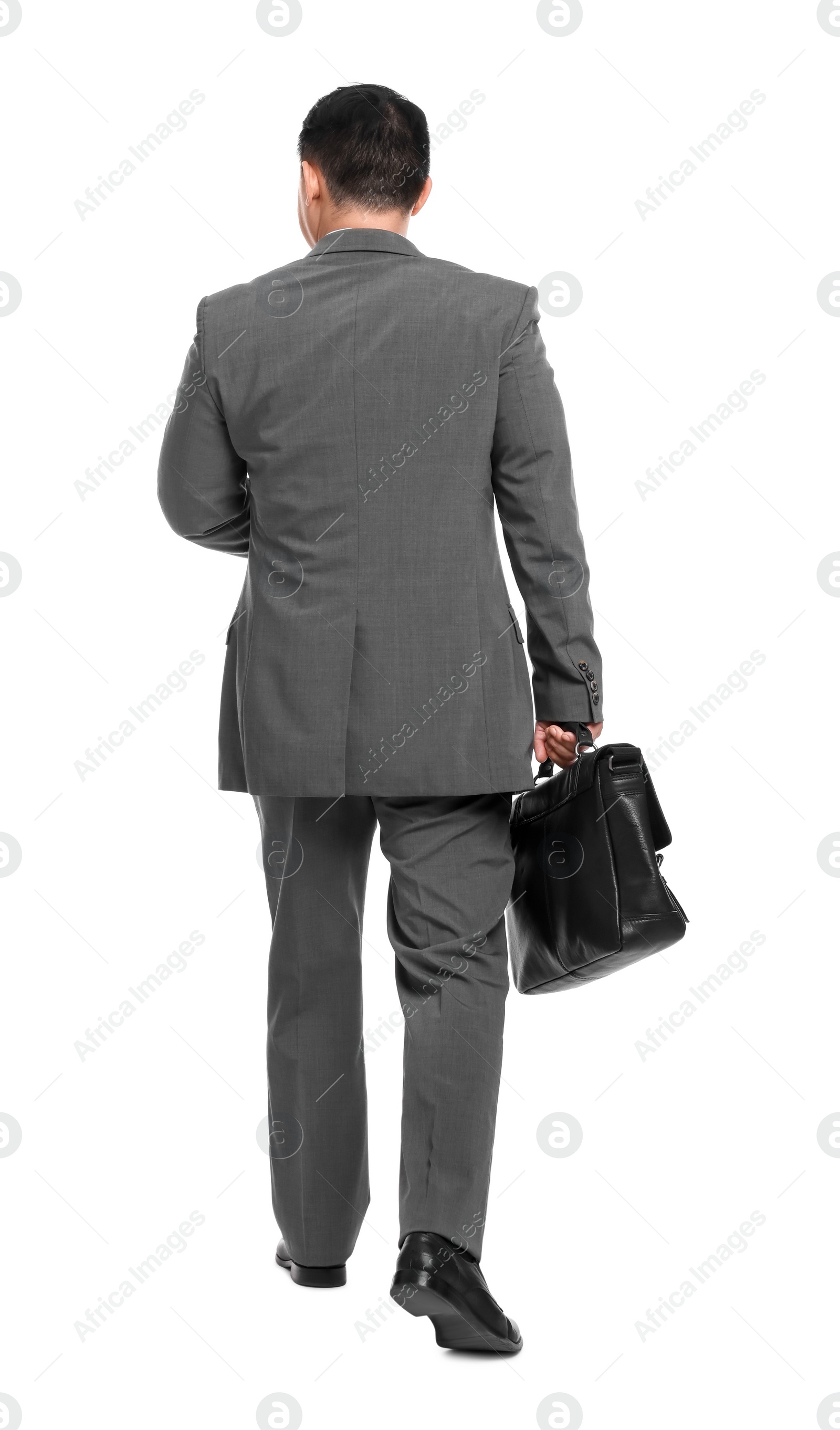 Photo of Businessman with briefcase walking on white background, back view