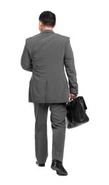 Businessman with briefcase walking on white background, back view