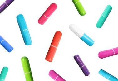 Image of Many tampons in colorful packages falling on white background