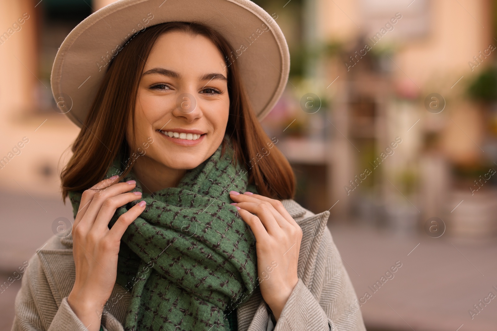 Photo of Beautiful woman in warm scarf and hat outdoors