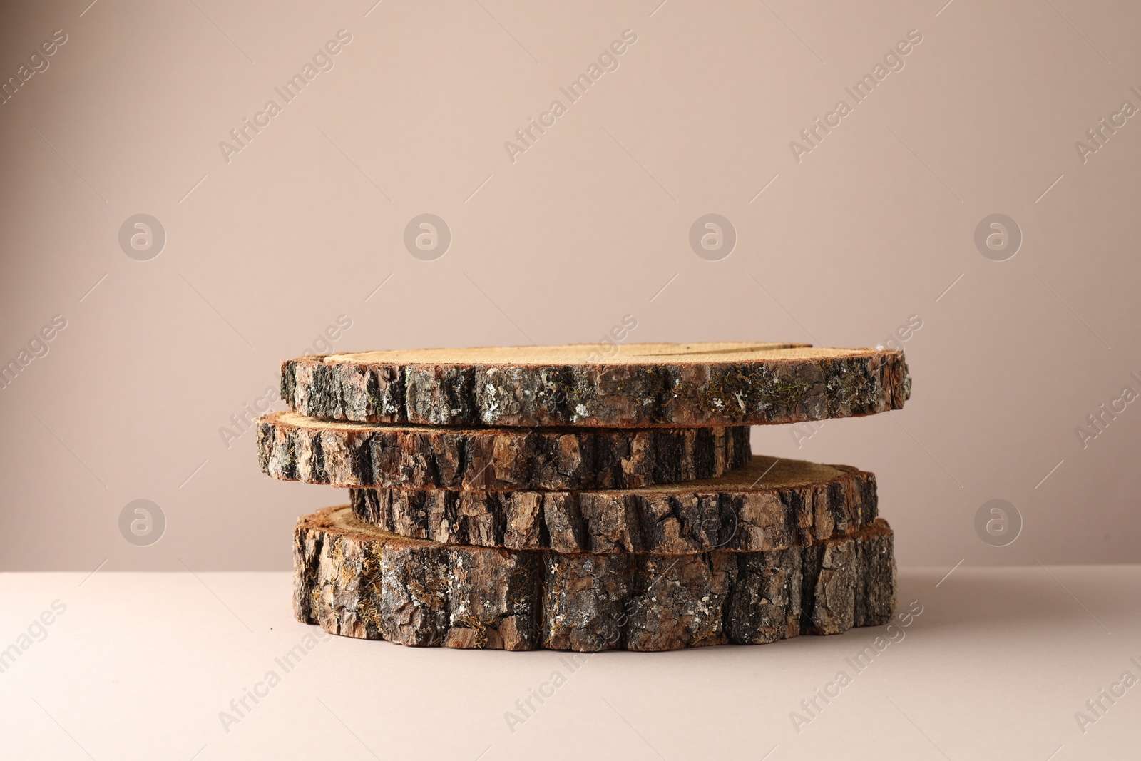 Photo of Presentation for product. Wooden stumps on beige background. Space for text