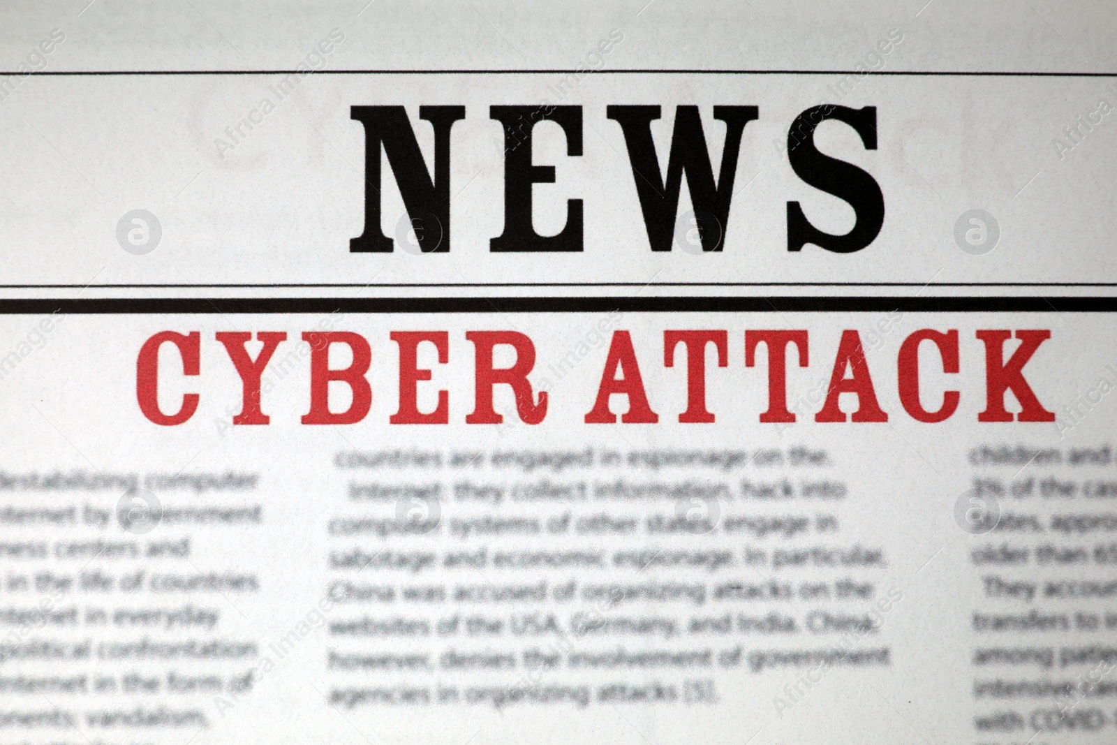 Photo of Top view of newspaper with headline CYBER ATTACK as background, closeup