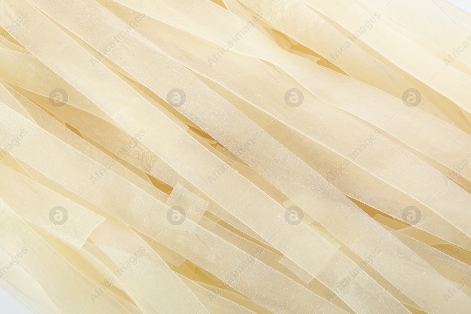 Photo of Raw rice noodles as background, closeup view