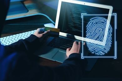 Image of Fingerprint identification. Man working with laptop at table, closeup