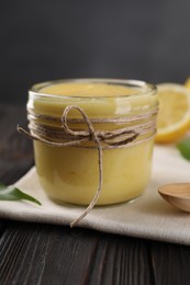 Photo of Delicious lemon curd in bowl on wooden table