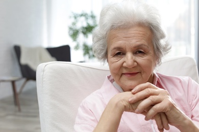 Portrait of mature woman in living room