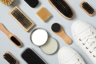 Flat lay composition with stylish footwear and shoe care accessories on white background