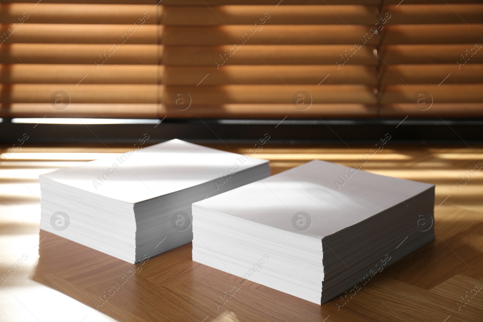 Photo of Stacks of paper sheets on wooden table